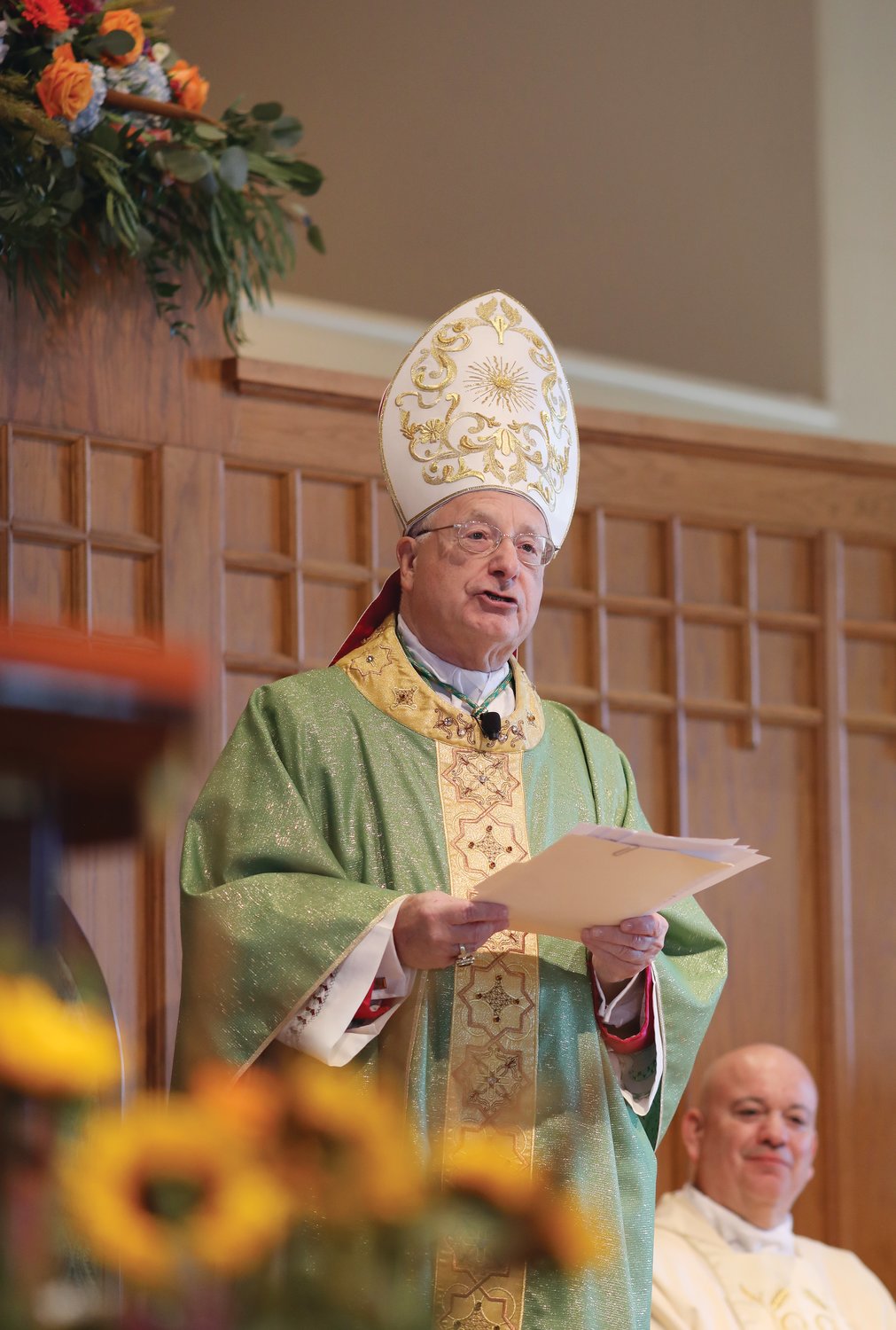 Bishop Evans presides over the installation Mass for Father William Ledoux, pastor, at Holy Apostles Church, Cranston, in 2021.  The bishop said that what he will miss most is “trying to be of service to my brother priests of the Diocese of Providence.”